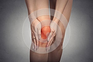 Tendon knee joint problems on woman leg indicated with red spot