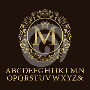 Tendrils gold letters with M initial monogram.