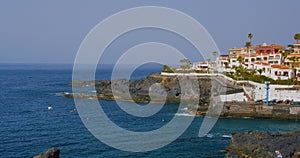 Tenerife, Canary Island, town with buildings Puerto de Santiago, Playa de Santiago. View of black rocky beach and