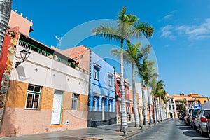Tenerife. Colourful houses and palm trees on street in Puerto de la Cruz town, Tenerife