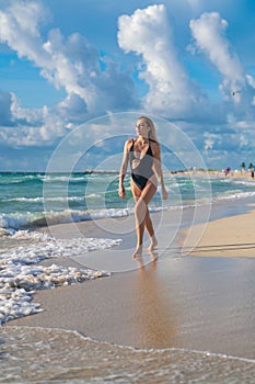 Tenerife. Sexy woman body on paradise tropical beach splashing water. Beautiful fit body girl on travel vacation. Hot