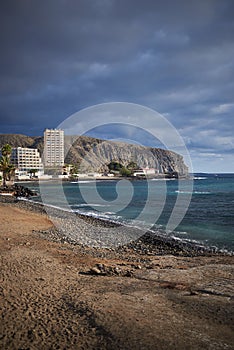 Tenerife shoreline with a beach, cliffs and buildings