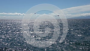 Tenerife, Spain - 29. July 2023: Boats and other vehicles doing watersports on the blue atlantic ocean