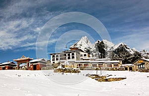 Tengboche Monastery with snow and blue sky photo