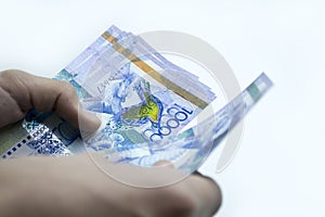 Tenge in the hands of a person, recalculation of funds.