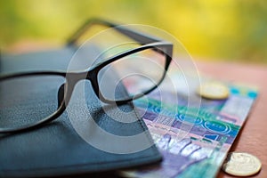 Tenge, Kazakh money and glasses on the table