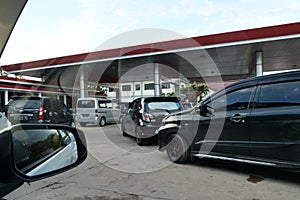 Tenggarong, Indonesia, December 2023, Cars queue line waiting for petrol in gas station