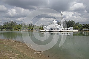 Kuala Ibai Floating Mosque or Masjid Tengu Tengah Zaharah and its reflection in the water. photo