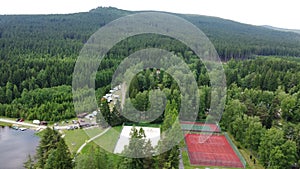 Tenis and beachvolleyball courts of OREA Resort Nine Rocks with nearby campground Vysocina near Milovsky Pond in