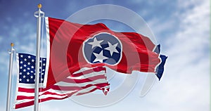 The Tennessee state flag waving along with the national flag of the United States of America