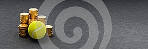 Tennis Ball ahead of Stacks of Coins on Dark Background