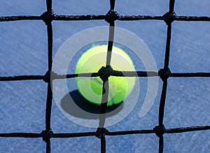 Tennis Ball Behind Tennis Net