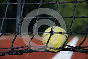 Tennis ball in the black net