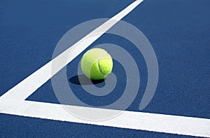 Tennis Ball on blue tennis court