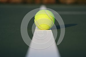 Tennis ball on court line
