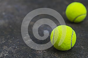 Tennis ball on the dirty ground