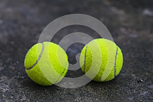 Tennis ball on the dirty ground