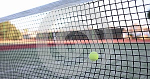 Tennis ball hits tennis net on tennis court