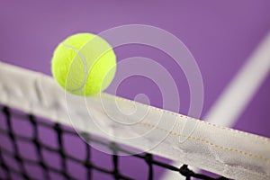 Tennis ball hitting the net