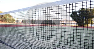 Tennis ball hitting net on tennis court