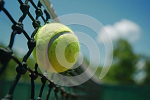 A tennis ball hitting a tennis court net