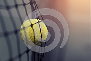 Tennis ball hitting the tennis net.