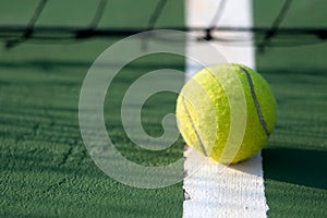 Tennis ball hitting the tennis net at tennis court.