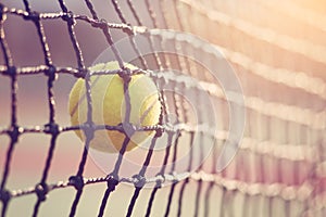 Tennis ball hitting the tennis net at tennis court.