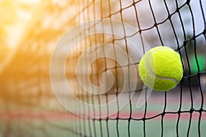Tennis ball hitting to net on blur court
