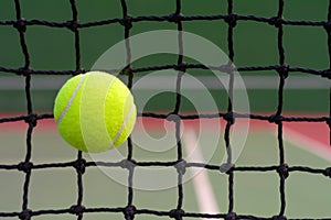 Tennis ball hitting to net on blur court background