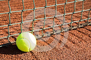 Tennis ball with line and net on a sand court