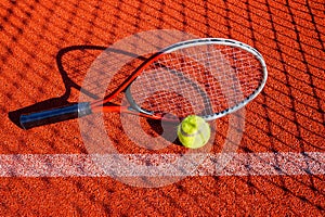 Tennis ball, racket and line on an outdoor court