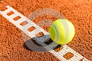 Tennis ball with line on a sand court