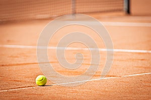 Tennis ball lying on line in sand