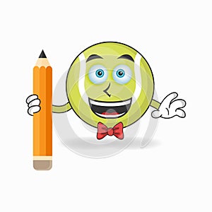 Tennis ball mascot character holding a pencil. vector illustration