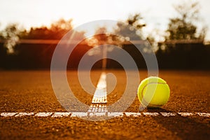 Tennis ball with net in background
