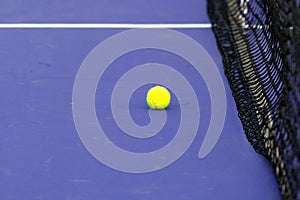 Tennis ball & net on court field