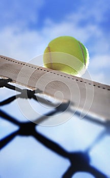 Tennis ball on netÃÂ´s edge photo