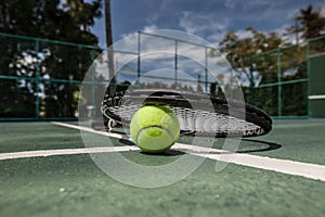 Tennis ball and racket on cort