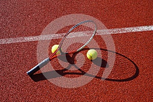 Tennis ball, racket and line on an outdoor court