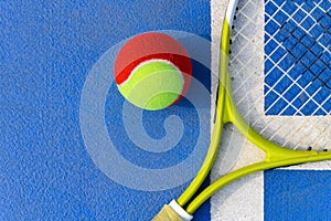 Tennis ball and racket in outdoor court