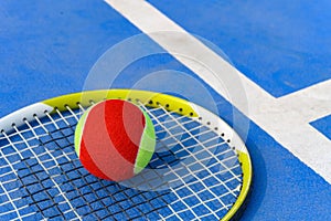 Tennis ball and racket in outdoor court