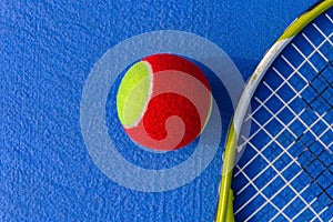 tennis ball and racket in outdoor court