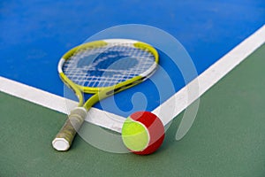 tennis ball and racket in outdoor court