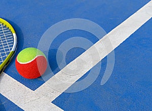 Tennis ball and racket in an outdoor court with copy space