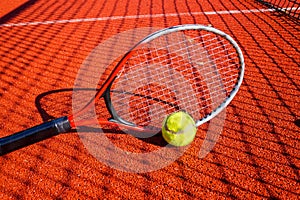 Tennis ball and racket on an outdoor court