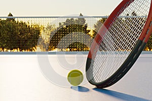 Tennis ball with racket on an outdoor sports court