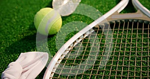 Tennis ball, racket, water bottle and hair band in tennis court 4k