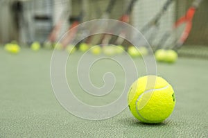 Tennis ball with the rackets and net at the background. Wallpaper.