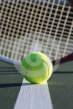 Tennis ball and racquet photo